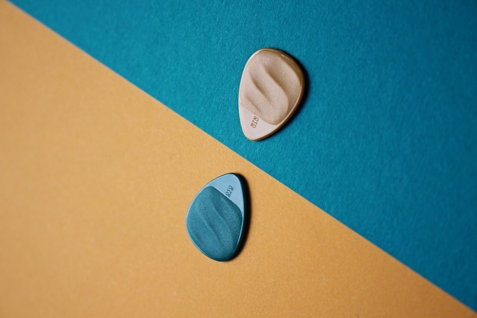 Guitar picks with different color backgrounds yellow and blue